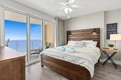 a bedroom with a bed with a view of the ocean at Beautiful Ocean Views! 2-Bedroom, 2-Bathroom! Resort Pools! in Panama City Beach