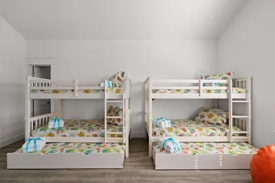 two bunk beds in a childs room at Brand NEW Expansive Coastal Home w/ Custom Furnishings Sleeps 15 in Panama City Beach