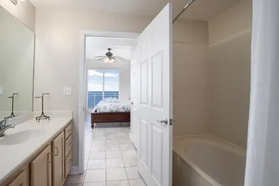 a bathroom with a sink and a tub and a bed at Penthouse! Beautiful Views! Newly Remodeled and Listed! in Panama City Beach