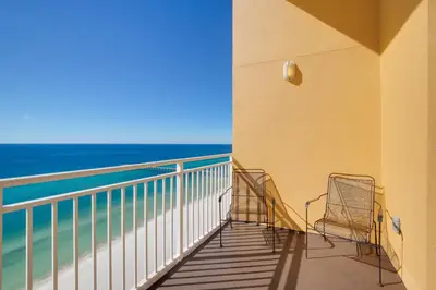 a balcony with two chairs and the ocean at Penthouse! Beautiful Views! Newly Remodeled and Listed! in Panama City Beach