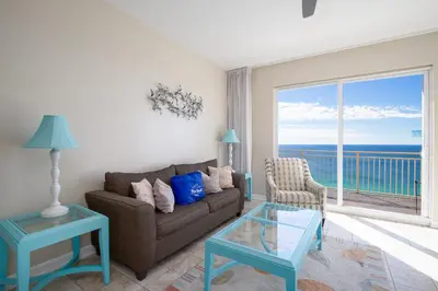 a living room with a couch and a view of the ocean at Penthouse! Beautiful Views! Newly Remodeled and Listed! in Panama City Beach
