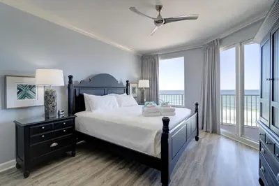 a bedroom with a bed with a view of the ocean at Gulf Front Master Suite! Directly On The Beach! 3 BR / 2 BA! Sleeps 8! in Panama City Beach