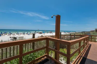 a deck with a view of the beach at Gulf Front Master Suite! Directly On The Beach! 3 BR / 2 BA! Sleeps 8! in Panama City Beach