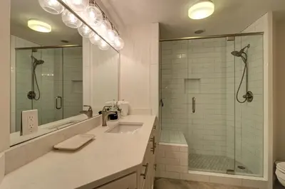 a bathroom with a sink and a glass shower at Stunning 2 BR/2 BA Third Floor Unit Directly On Santa Rosa Beach! Sleeps 6! in Santa Rosa Beach