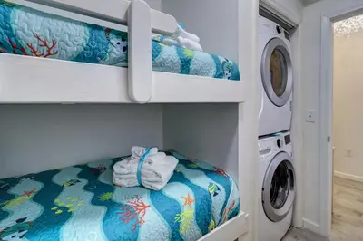 a laundry room with a washer and dryer at Stunning 2 BR/2 BA Third Floor Unit Directly On Santa Rosa Beach! Sleeps 6! in Santa Rosa Beach