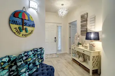 a living room with a blue couch and a table at Stunning 2 BR/2 BA Third Floor Unit Directly On Santa Rosa Beach! Sleeps 6! in Santa Rosa Beach