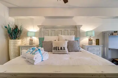 a large white bed with pillows and towels on it at Stunning 2 BR/2 BA Third Floor Unit Directly On Santa Rosa Beach! Sleeps 6! in Santa Rosa Beach