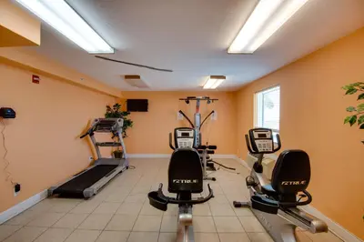 a gym with treadmills and ellipticals in a room at Large Balcony! Gulf Front Master Suite! Many Amenities On-Site! in Panama City Beach