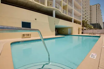 a swimming pool at a hotel with a building at Large Balcony! Gulf Front Master Suite! Many Amenities On-Site! in Panama City Beach