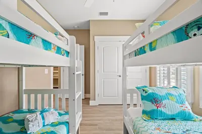 a bunk bed room with two bunk beds at Charming Retreat, a Short Walk to Laguna Beach, with Room for 10! in Panama City Beach