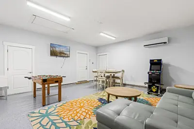 a living room with a couch and a table at Charming Retreat, a Short Walk to Laguna Beach, with Room for 10! in Panama City Beach