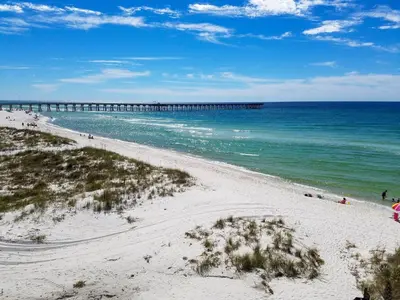 a view of a beach with a pier in the water at Spacious Waterfront Townhome - Just A Short Walk to Pier Park in Panama City Beach