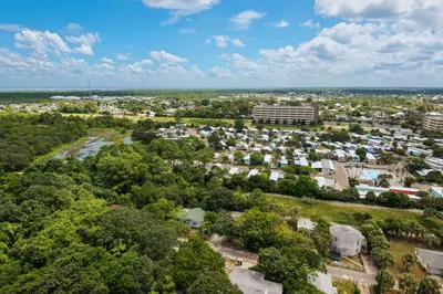 an aerial view of a city with trees and buildings at Across From The Beach! Near Pier Park & Dining! Sleeps 6! 2 BR / 2 BA! in Panama City Beach