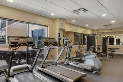 a gym with treadmills and elliptical machines at Across From The Beach! Near Pier Park & Dining! Sleeps 6! 2 BR / 2 BA! in Panama City Beach