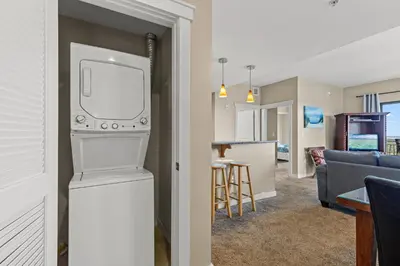 a living room and kitchen with a tv and a living room at Across From The Beach! Near Pier Park & Dining! Sleeps 6! 2 BR / 2 BA! in Panama City Beach