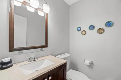 a bathroom with a sink and a mirror at 120 Palm Beach Dr A - La Casa Turquesa in Panama City Beach