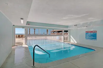 a large swimming pool in a building at NEW PROPERTY! Vacation Right on the Gulf in Sand & Seafoam Villa Sleeps 6! in Panama City Beach