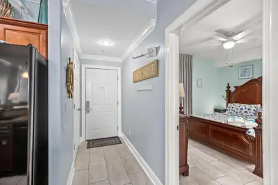 a hallway with a door leading to a bedroom at NEW PROPERTY! Vacation Right on the Gulf in Sand & Seafoam Villa Sleeps 6! in Panama City Beach