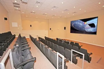 a conference room with black chairs and a large screen at Sleep in Comfort in The Most Spacious 2 Bedrooms Tidewater Has to Offer in Panama City Beach