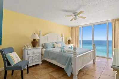 a bedroom with a bed with a view of the ocean at Beautiful Long Beach Condo unit 1-1206! TWO Gulf Masters! in Panama City Beach