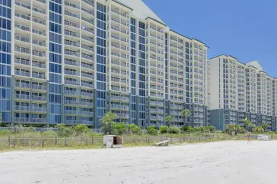 a large building on the beach next to a beach at Beautiful Long Beach Condo unit 1-1206! TWO Gulf Masters! in Panama City Beach