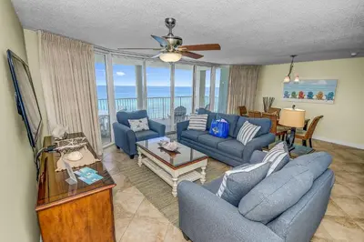a living room with blue furniture and a view of the ocean at Beautiful Long Beach Condo unit 1-1206! TWO Gulf Masters! in Panama City Beach