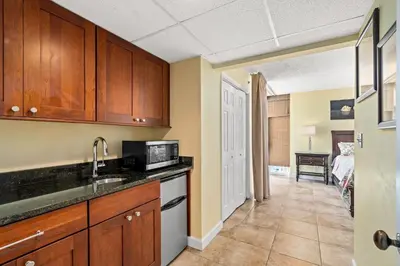 a kitchen with a sink and a microwave at Beautiful Long Beach Condo unit 1-1206! TWO Gulf Masters! in Panama City Beach