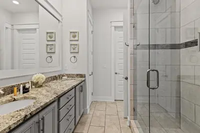 a bathroom with a shower and a sink at 24 York Lane | Edgewater Escape in Inlet Beach