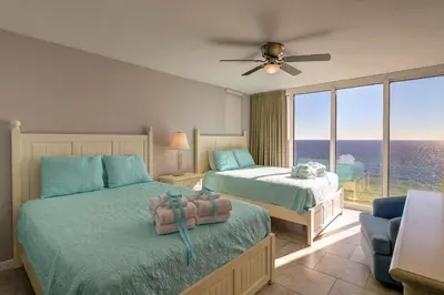 a bedroom with two beds and a large window at Amazing Views! Newly Listed! Family Friendly Unit! Resort Pools! in Panama City Beach