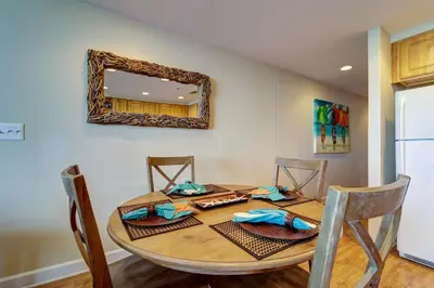 a dining room table with a mirror on the wall at Gulf Front! 2 BR 2 BA! 11th Floor condo + Condo Amenities! in Panama City Beach