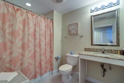 a bathroom with a toilet and a sink and a shower at Gulf Front! 2 BR 2 BA! 11th Floor condo + Condo Amenities! in Panama City Beach