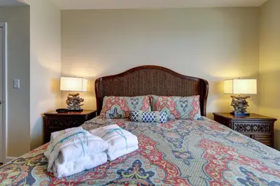 a bedroom with two towels on a bed with two lamps at Gulf Front! 2 BR 2 BA! 11th Floor condo + Condo Amenities! in Panama City Beach