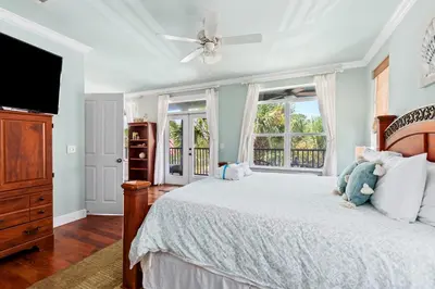 a bedroom with a bed and a ceiling fan at 109 Island Cove Ct - Blue Palm Cove in Panama City Beach