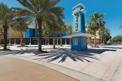 a blue sign in front of a building with palm trees at 109 Island Cove Ct - Blue Palm Cove in Panama City Beach