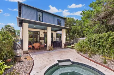 a home with a swimming pool in the yard at 109 Island Cove Ct - Blue Palm Cove in Panama City Beach