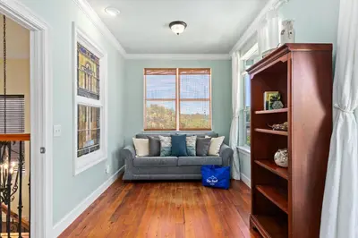 a living room with a couch and a window at 109 Island Cove Ct - Blue Palm Cove in Panama City Beach