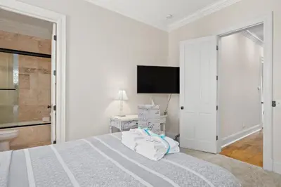 a white bedroom with a bed and a tv at Feel Like Luxury Vacationing in this Private Community in Seagrove on 30A in Santa Rosa Beach