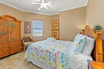a bedroom with a bed and a dresser at Gulf Front Master Bedroom, 2 Pools & Hot Tubs, Sleeps 8 in Panama City Beach