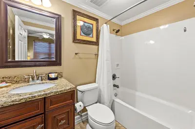 a bathroom with a toilet and a sink and a shower at Gulf Front Master Bedroom, 2 Pools & Hot Tubs, Sleeps 8 in Panama City Beach