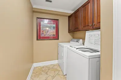 a laundry room with a washer and dryer at Gulf Front Master Bedroom, 2 Pools & Hot Tubs, Sleeps 8 in Panama City Beach