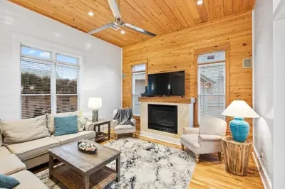 a living room with a couch and a fireplace at 12 Periwinkle Ln - Beach Blessings in Santa Rosa Beach
