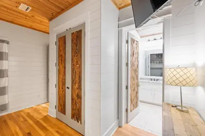 a hallway with white walls and wood ceilings at 12 Periwinkle Ln - Beach Blessings in Santa Rosa Beach