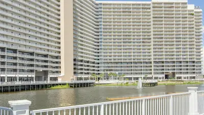 a large building next to a body of water at Laketown Wharf 911 - Luxury at the Wharf in Panama City Beach