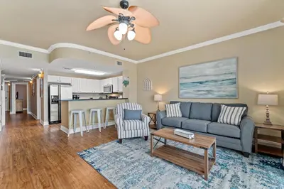 a living room with a couch and a table at Right Across The Street From Pier Park! 2 Pools Overlooking Gulf!Next To Pier in Panama City Beach