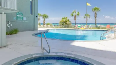 a swimming pool with the ocean in the background at The Perfect Escape! Long Beach Resort-8th Floor-Gulf Front with AMAZING views in Panama City Beach