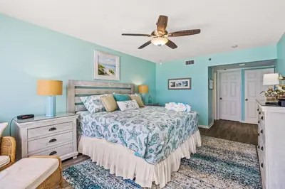 a bedroom with a bed and a ceiling fan at The Perfect Escape! Long Beach Resort-8th Floor-Gulf Front with AMAZING views in Panama City Beach
