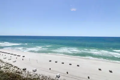 a beach with a row of chairs and the ocean at The Perfect Escape! Long Beach Resort-8th Floor-Gulf Front with AMAZING views in Panama City Beach