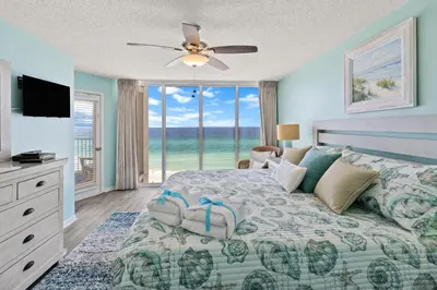 a bedroom with a bed with a view of the ocean at The Perfect Escape! Long Beach Resort-8th Floor-Gulf Front with AMAZING views in Panama City Beach
