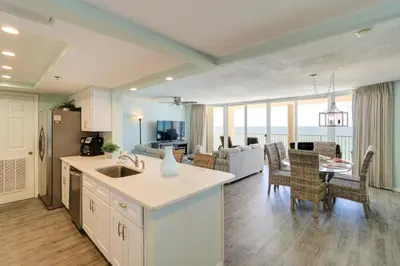 a kitchen and living room with a dining room and a living room at The Perfect Escape! Long Beach Resort-8th Floor-Gulf Front with AMAZING views in Panama City Beach