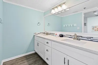 a bathroom with a sink and a large mirror at The Perfect Escape! Long Beach Resort-8th Floor-Gulf Front with AMAZING views in Panama City Beach